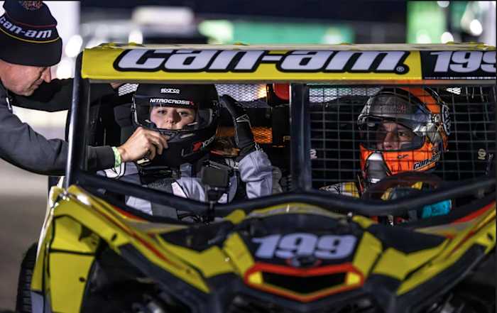 Auto Racing Digest's Victoria Beaver (left) gets set to go play in the sand with Travis Pastrana behind the wheel (right). Photo: Long Nguyen.